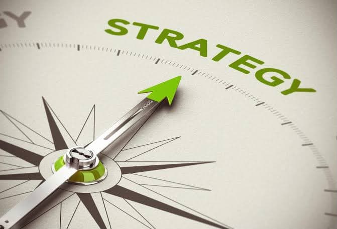A compass needle pointing to the word strategy.